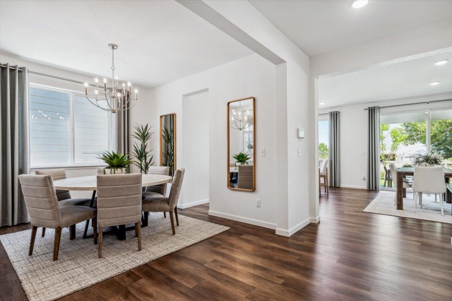 A dining room with a wood floor. A dining room with a wood floor.