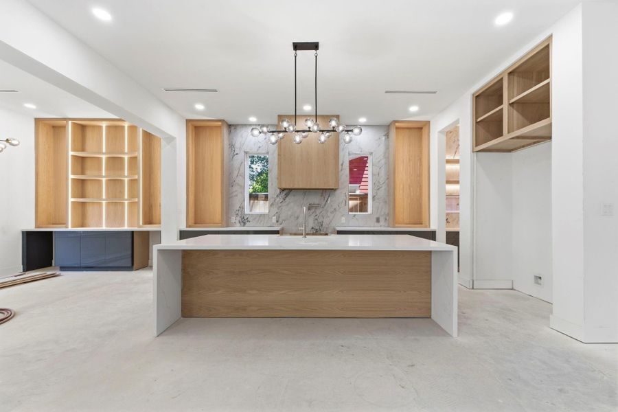 This photo showcases the center island with a clear view, and to the right, a built-in Thermador refrigerator will be installed. This photo showcases the center island with a clear view, and to the right, a built-in Thermador refrigerator will be installed.