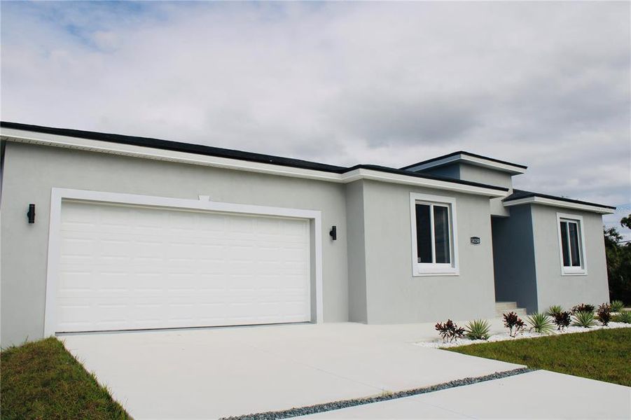 Front exterior of a new home in , Port Charlotte, FL, highlighting curb appeal (Image 25).