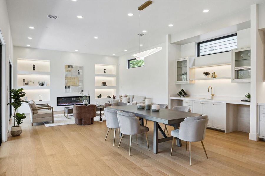 Bright living space with hardwood floors, high-end custom shelving, and designer finishes. Bright living space with hardwood floors, high-end custom shelving, and designer finishes.