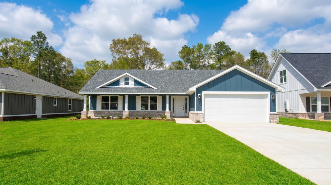 Front exterior of a new home in Blossom Grove, Milton, FL, highlighting curb appeal (Image 1). Front exterior of a new home in Blossom Grove, Milton, FL, highlighting curb appeal (Image 1).