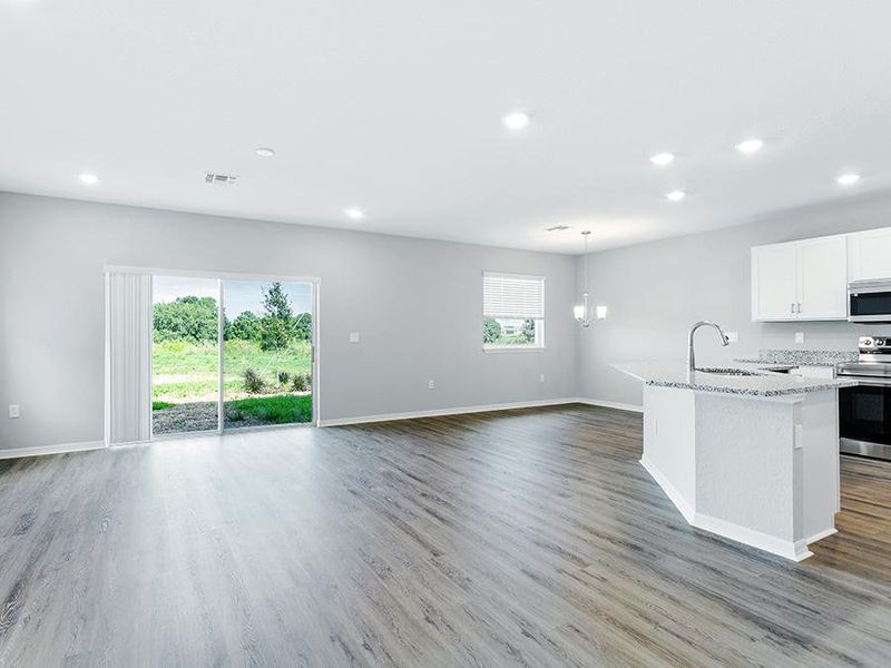 Enjoy a sunny, open living area finished with luxury vinyl plank flooring.