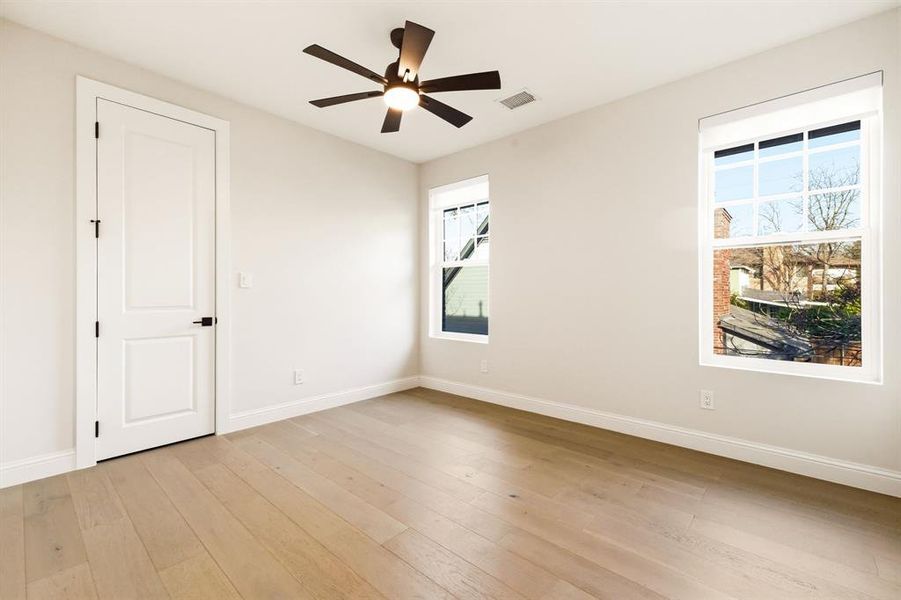 Spare room featuring light wood-style flooring and ceiling fan