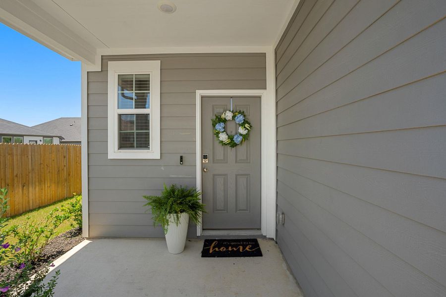A welcoming entry, with a subtle wreath adorning the front door.