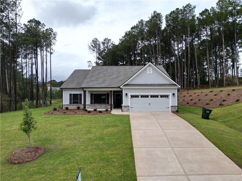 Front exterior of a new home in Red Oak Ridge, Loganville, GA, highlighting curb appeal (Image 1). Front exterior of a new home in Red Oak Ridge, Loganville, GA, highlighting curb appeal (Image 1).