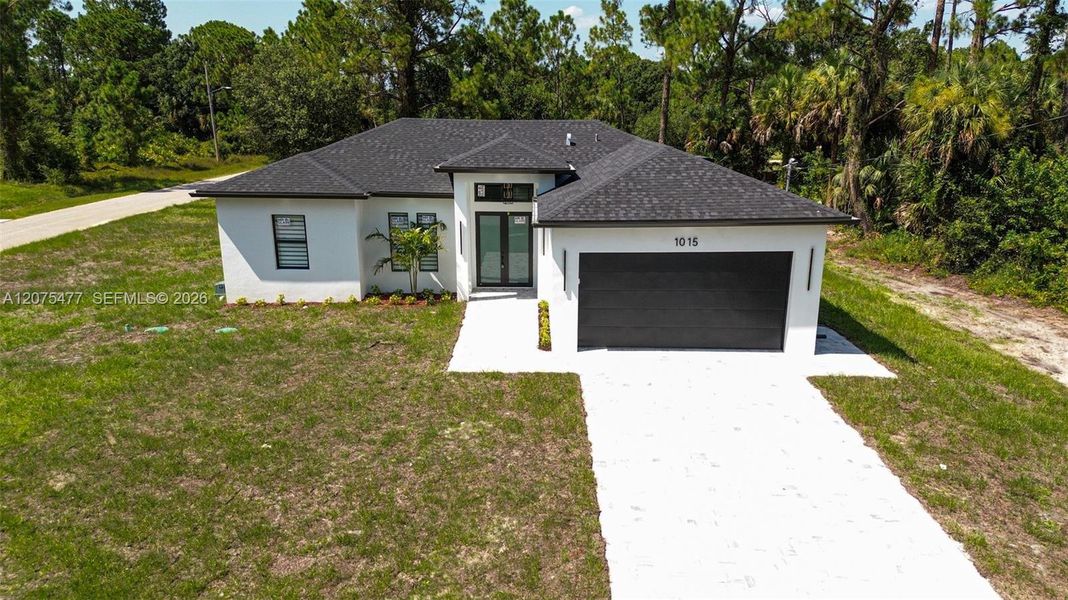 Front exterior of a new home in , Lehigh Acres, FL, highlighting curb appeal (Image 34). Front exterior of a new home in , Lehigh Acres, FL, highlighting curb appeal (Image 34).