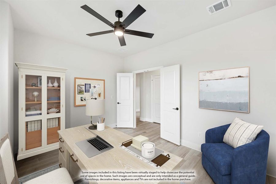 Home office with wood desk, ceiling fan, built-in cabinet, and light wood floors
