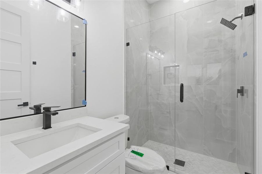 Full bathroom with vanity and a marble finish shower