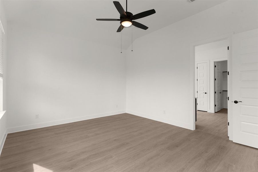 Empty room with wood finished floors and ceiling fan Empty room with wood finished floors and ceiling fan