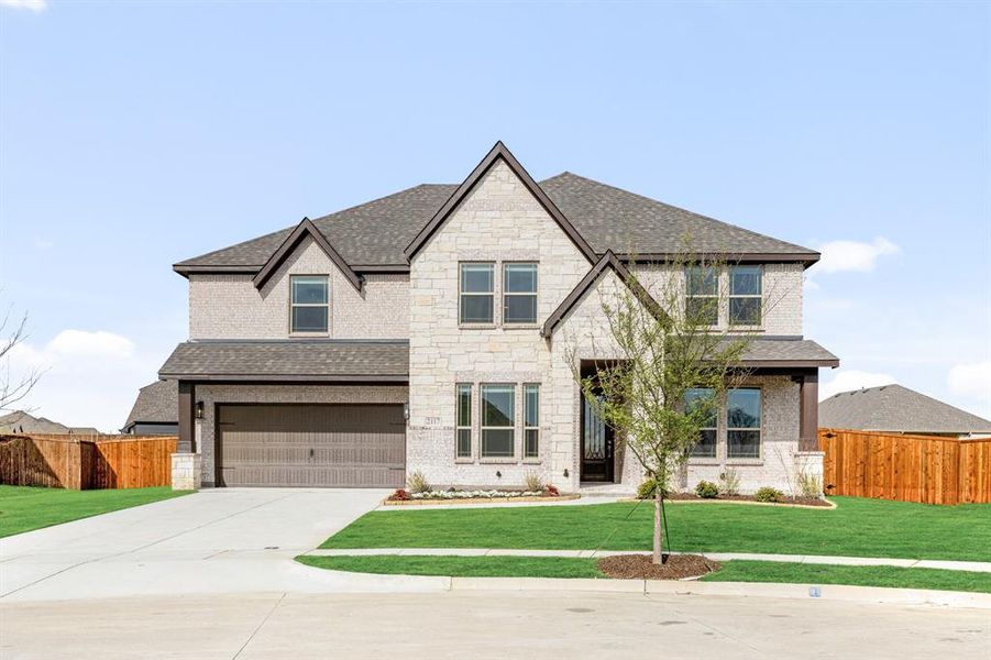 Front exterior of a new home in ArrowBrooke, Aubrey, TX, highlighting curb appeal (Image 26). Front exterior of a new home in ArrowBrooke, Aubrey, TX, highlighting curb appeal (Image 26).
