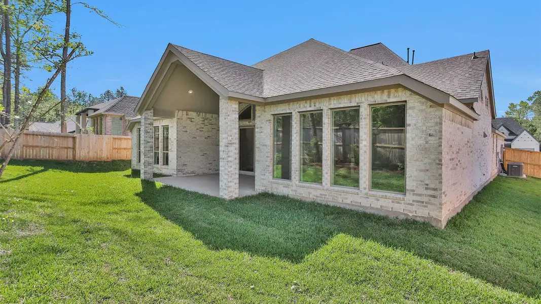 Front exterior of a new home in The Woodlands Hills 75', Willis, TX, highlighting curb appeal (Image 14).