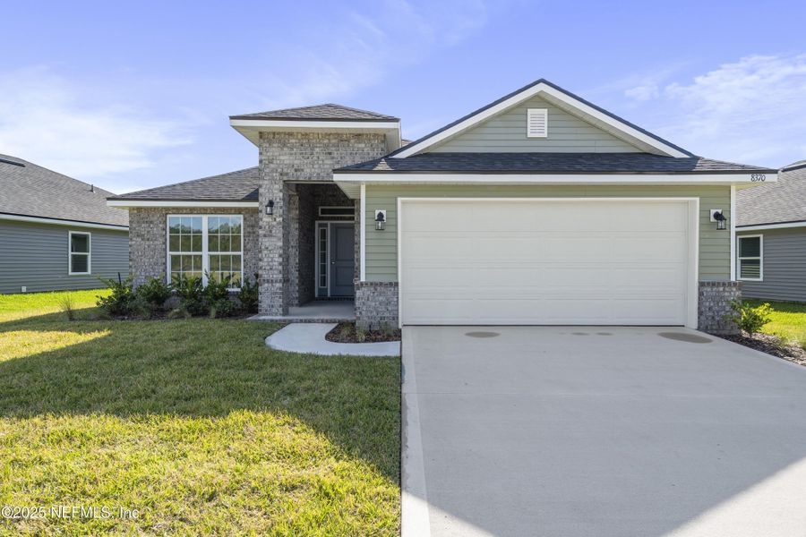 Front exterior of a new home in Summerglen, Jacksonville, FL, highlighting curb appeal (Image 1).