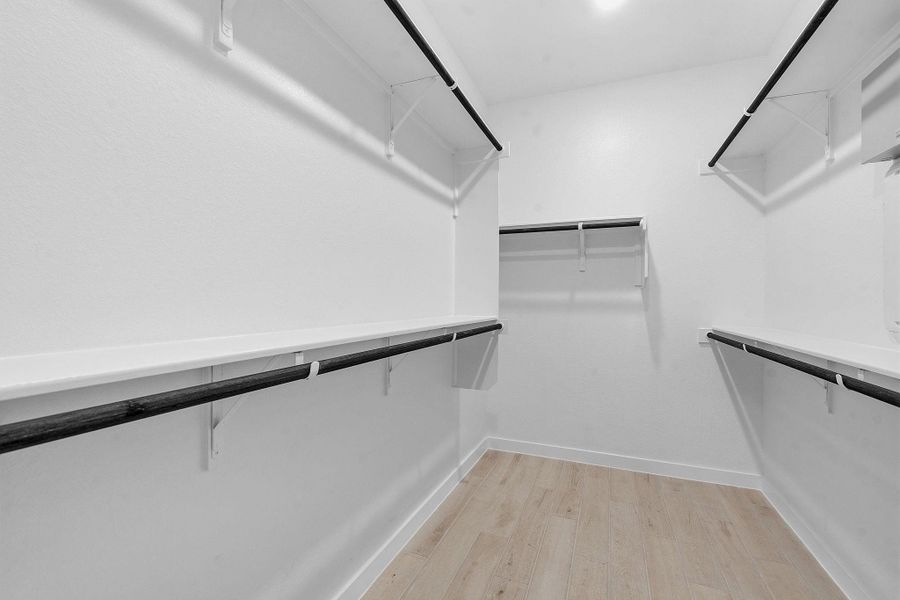 Ample shelving and hanging space defines this generously sized walk-in closet.