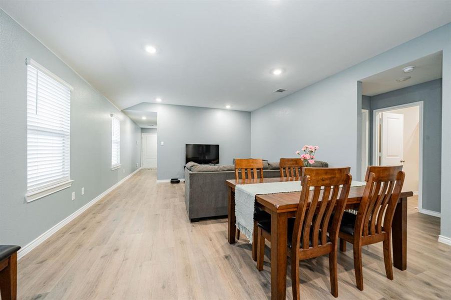 Dining room with light wood-type flooring and recessed lighting Dining room with light wood-type flooring and recessed lighting