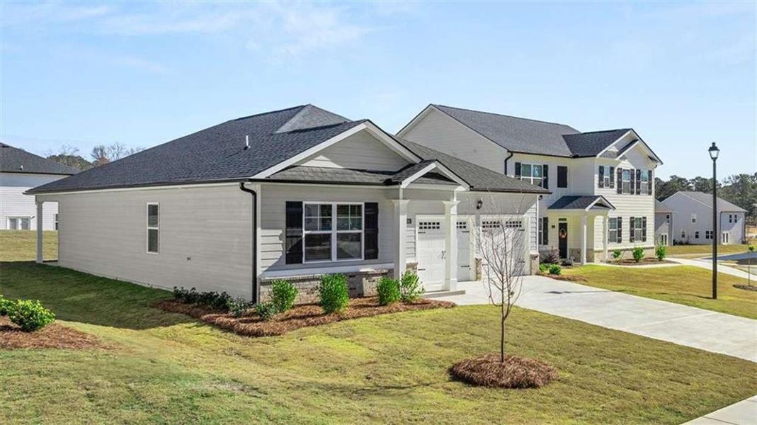 Front exterior of a new home in Oakchase at Hampton, Hampton, GA, highlighting curb appeal (Image 20). Front exterior of a new home in Oakchase at Hampton, Hampton, GA, highlighting curb appeal (Image 20).