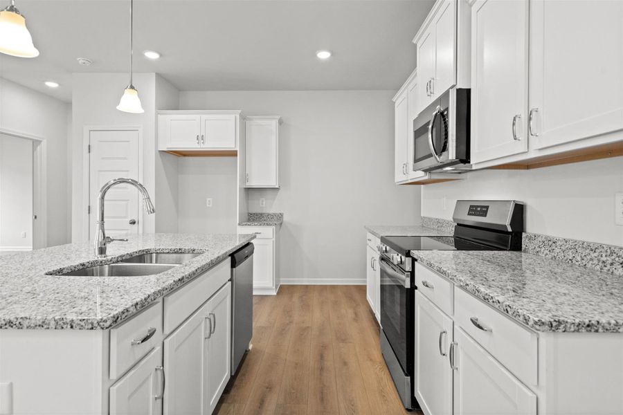 The Dove- Kitchen. Home under construction, photo used for illustrative purposes only, colors and options will vary.
