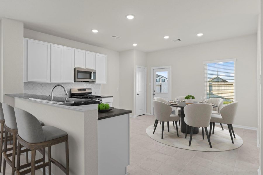 Virtually staged to feature the open flow between the kitchen and breakfast area, this layout is perfect for both casual dining and entertaining. The kitchen boasts granite countertops, sleek cabinetry, and a large breakfast bar for additional seating.