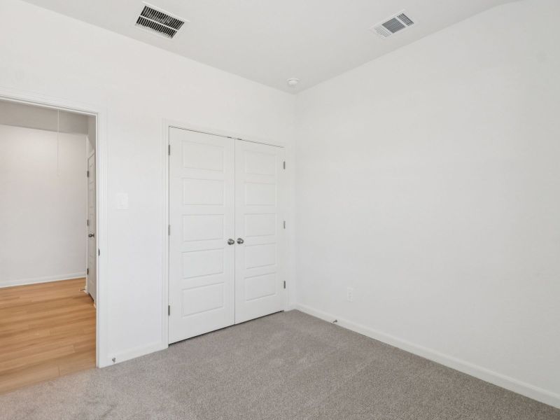 Guest bedroom in the Callaghan floorplan at a Meritage Homes community. Guest bedroom in the Callaghan floorplan at a Meritage Homes community.