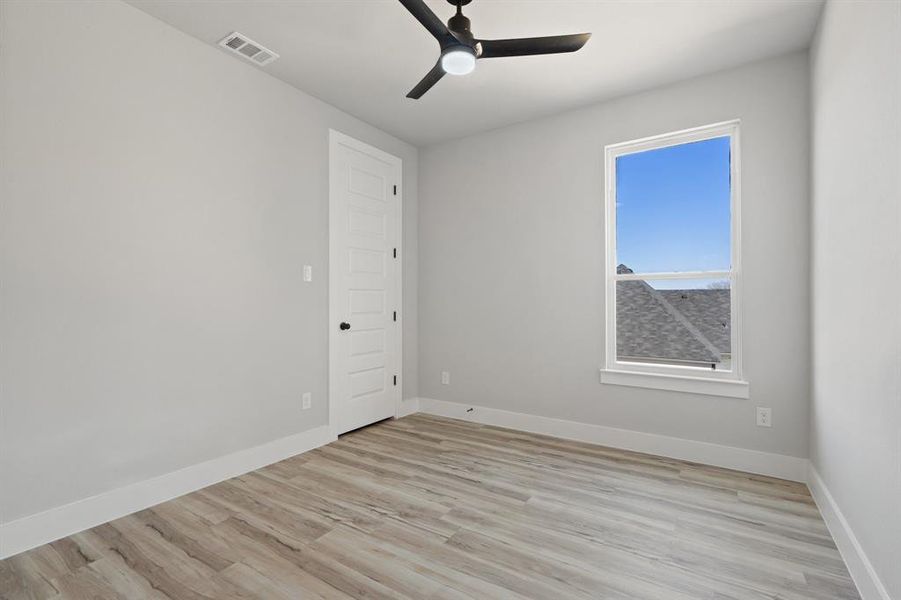 Spare room featuring ceiling fan and light wood-type flooring