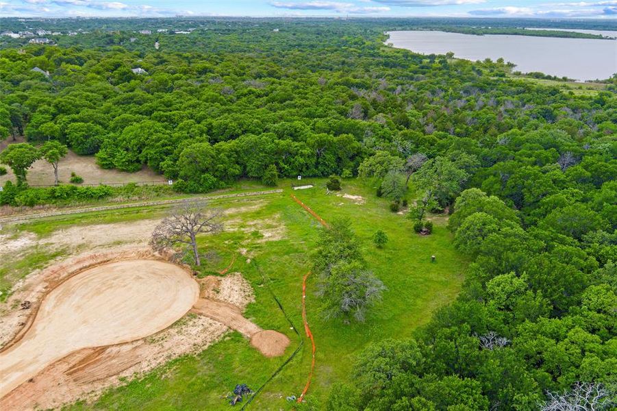 Expansive lot with partial clearing, surrounded by abundant mature trees and natural green spaces Expansive lot with partial clearing, surrounded by abundant mature trees and natural green spaces