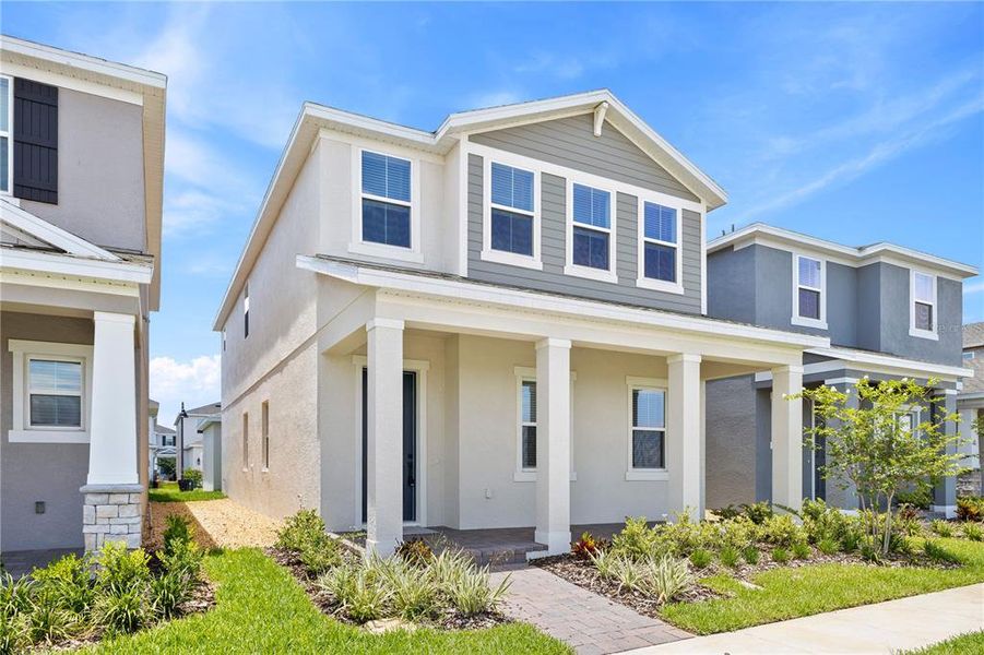 Front exterior of a new home in Osprey Ranch, Winter Garden, FL, highlighting curb appeal (Image 24).