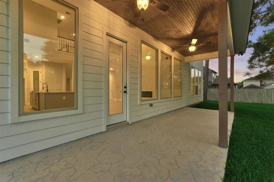 Porch has been finished out with a wood plank ceiling.