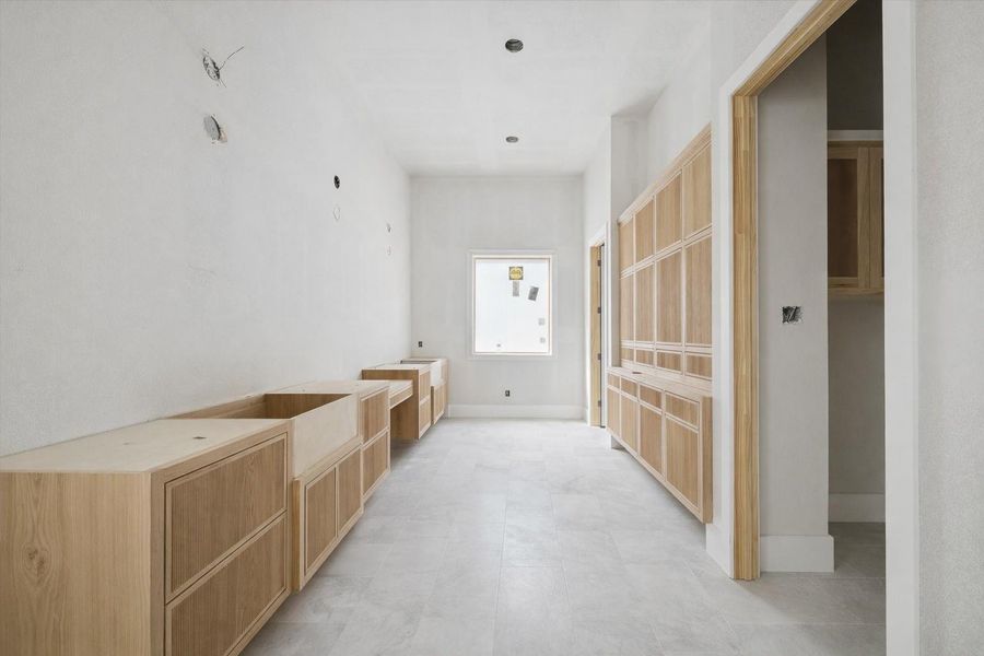 A spacious vanity area designed for comfort and efficiency. Generous cabinetry provides abundant storage while maintaining a sleek, custom feel. The layout allows for a refined yet practical daily routine, with room to incorporate statement mirrors and designer lighting for a truly elevated finish. A spacious vanity area designed for comfort and efficiency. Generous cabinetry provides abundant storage while maintaining a sleek, custom feel. The layout allows for a refined yet practical daily routine, with room to incorporate statement mirrors and designer lighting for a truly elevated finish.