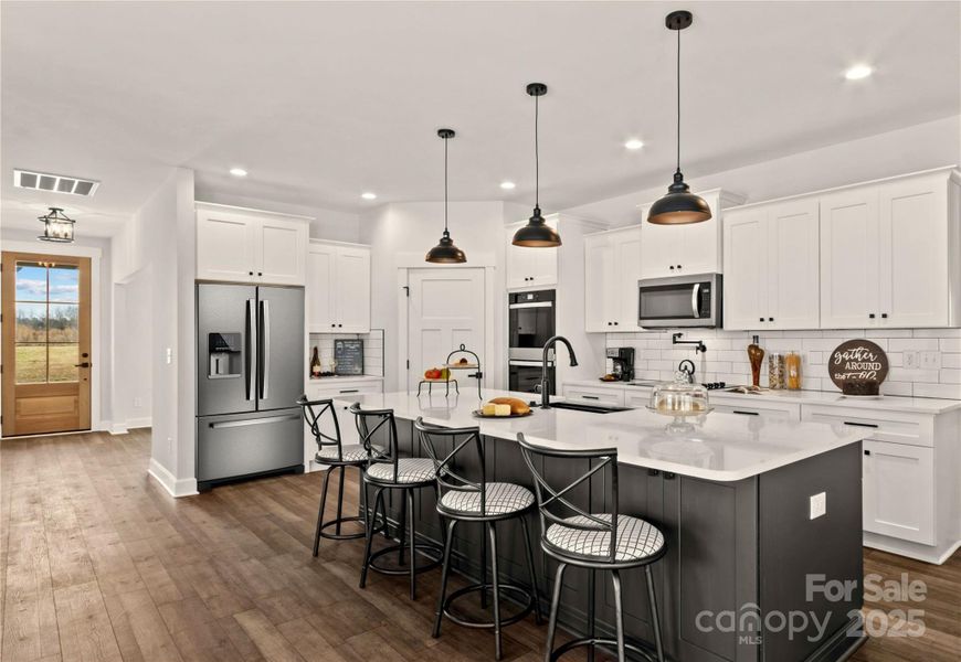 Kitchen with 10 Foot Quartz Island & Double Oven & Pot filler.