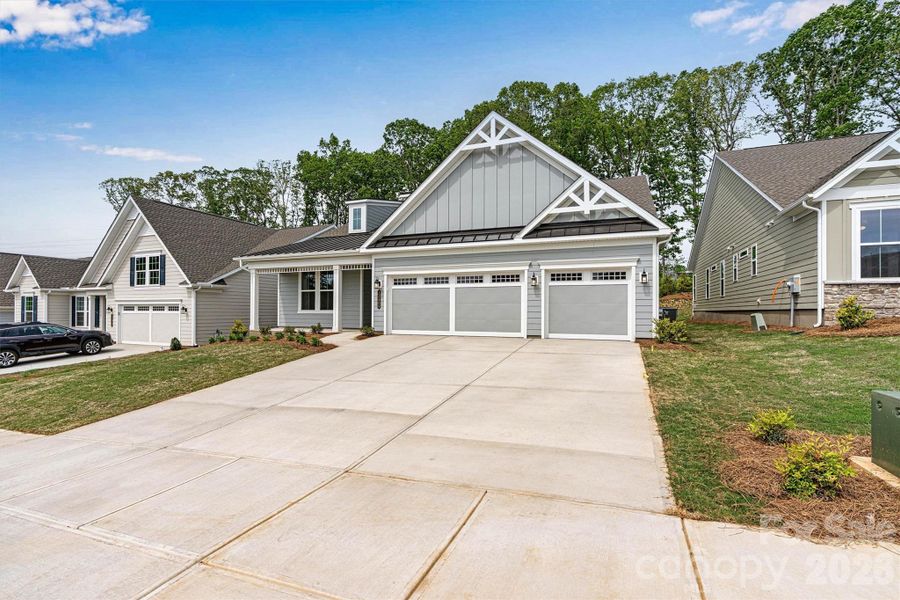 Front exterior of a new home in Cresswind Charlotte, Mint Hill, NC, highlighting curb appeal (Image 1). Front exterior of a new home in Cresswind Charlotte, Mint Hill, NC, highlighting curb appeal (Image 1).