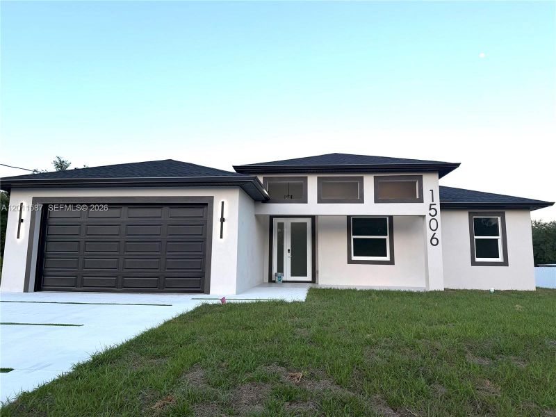 Front exterior of a new home in , Lehigh Acres, FL, highlighting curb appeal (Image 20).