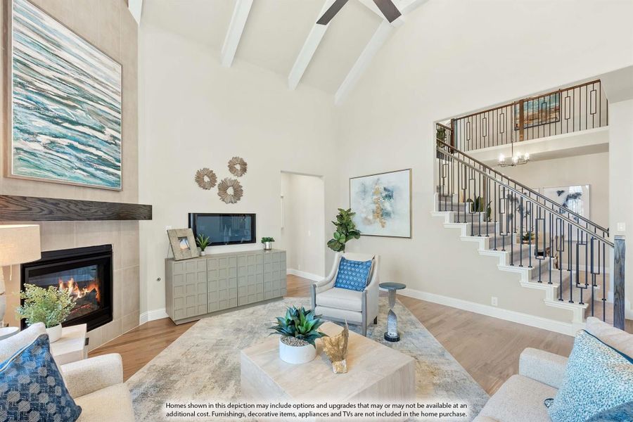 Living room with vaulted beamed ceiling, fireplace, hardwood floors, and open staircase to second floor. Living room with vaulted beamed ceiling, fireplace, hardwood floors, and open staircase to second floor.