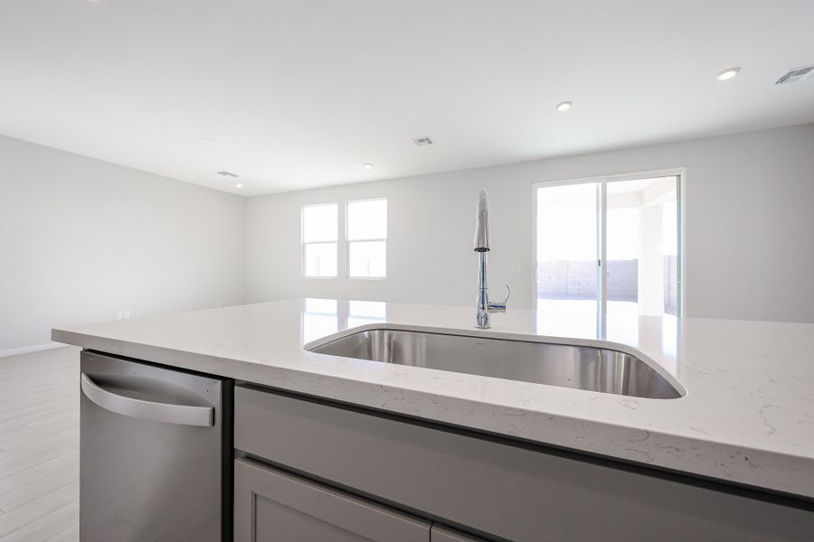 A kitchen with a sink and a window. A kitchen with a sink and a window.
