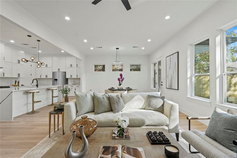 Living area featuring light wood finished floors and recessed lighting