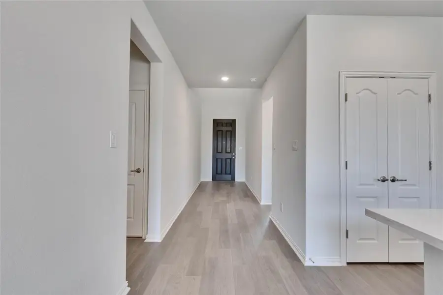 Hall featuring light wood-style flooring, baseboards, and recessed lighting Hall featuring light wood-style flooring, baseboards, and recessed lighting