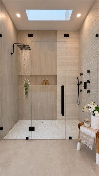 Body sprays, rainfall, and natural skylight await you in the primary shower.