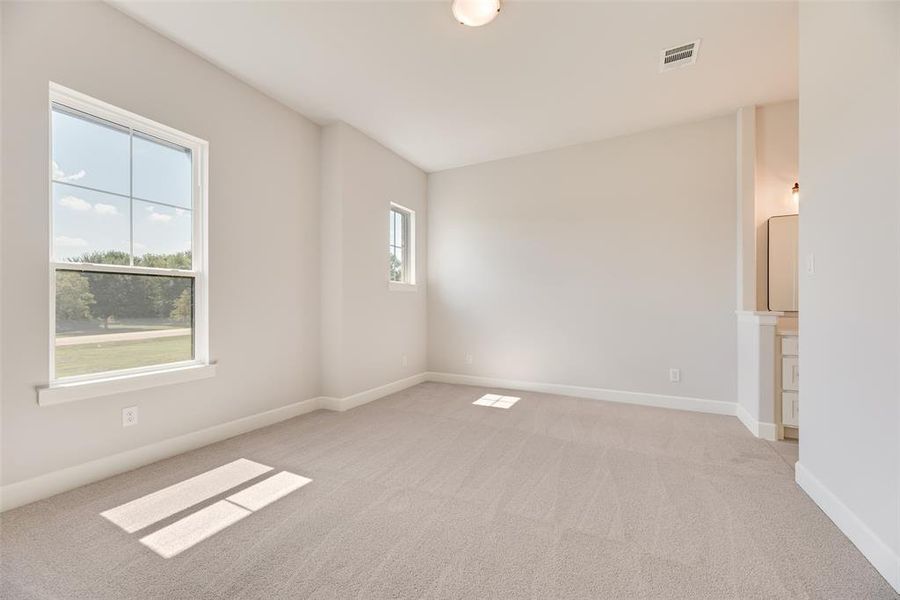 Empty room with light carpet and baseboards