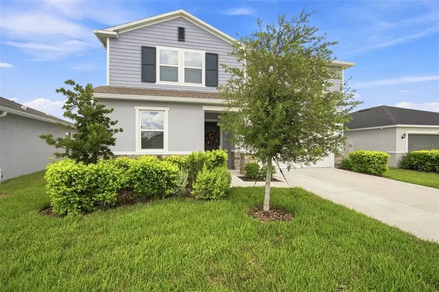 Front exterior of a new home in , Land O' Lakes, FL, highlighting curb appeal (Image 23).