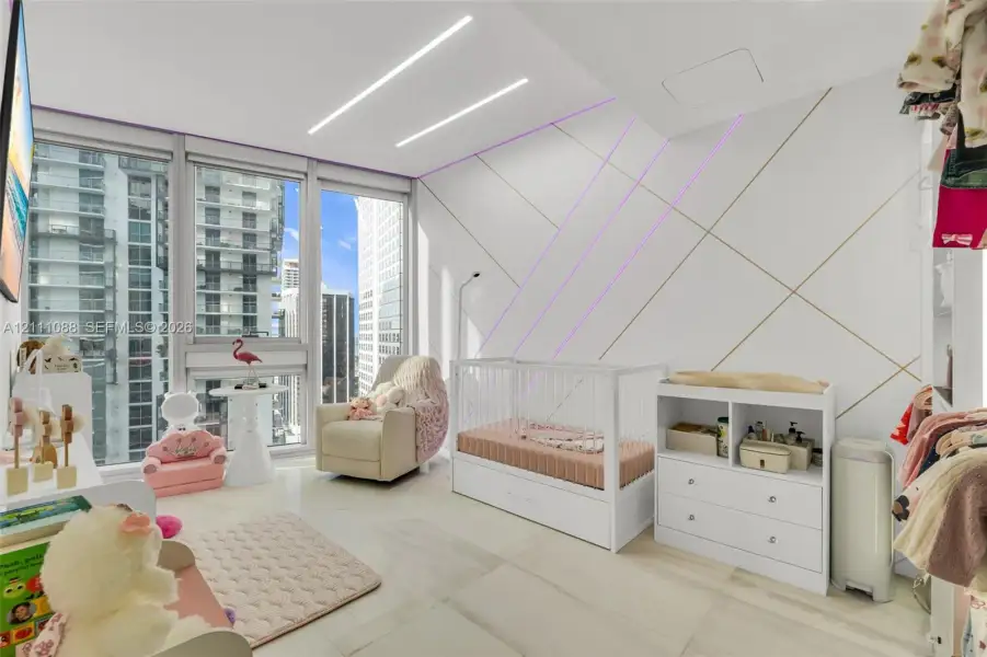 Floor-to-ceiling windows, custom geometric wall paneling with integrated lighting, and polished stone-finish flooring Floor-to-ceiling windows, custom geometric wall paneling with integrated lighting, and polished stone-finish flooring