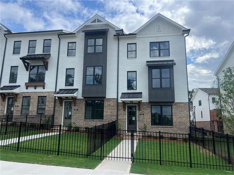 Front exterior of a new home in Palisades Townhomes, Cumming, GA, highlighting curb appeal (Image 29). Front exterior of a new home in Palisades Townhomes, Cumming, GA, highlighting curb appeal (Image 29).
