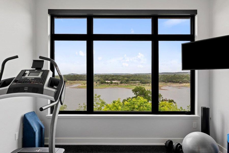 Stay motivated in the private fitness center, where expansive windows provide an inspiring backdrop of Lake Travis and the rolling hills while you train.