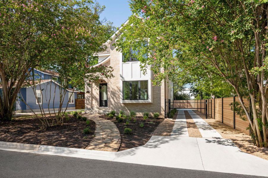 A well-landscaped yard with mature trees and a paved driveway welcomes you to this charming brick residence.