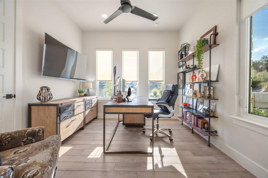 Office area featuring ceiling fan and light wood-type flooring Office area featuring ceiling fan and light wood-type flooring