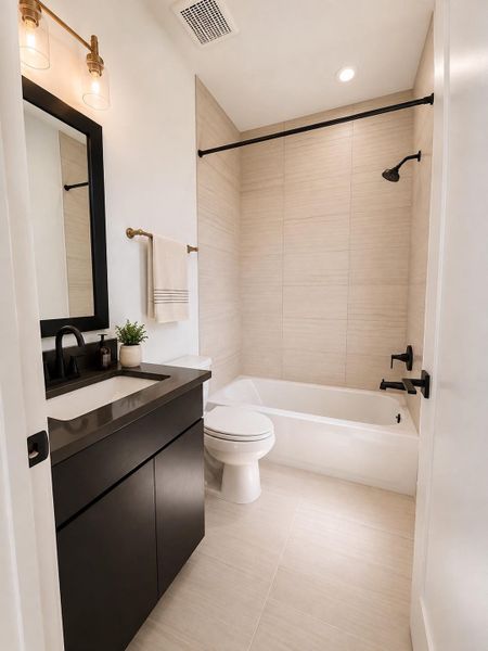 Modern fixtures and smooth tile accents define this functional and serene bath space.