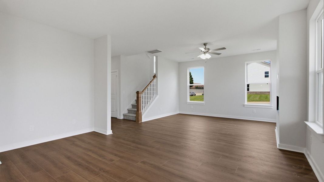View from dining area into the living room with access to second floor