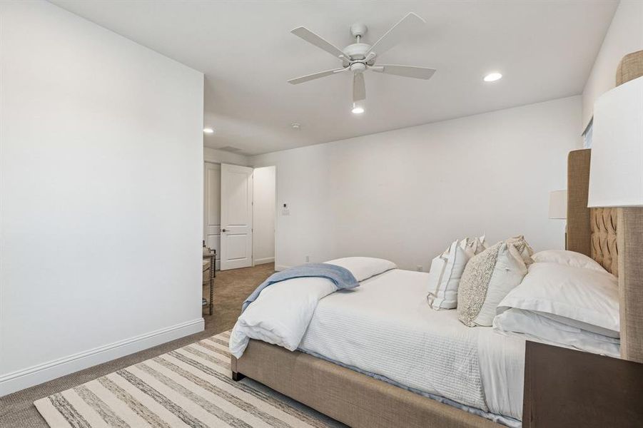 Bedroom featuring light colored carpet, recessed lighting, and ceiling fan