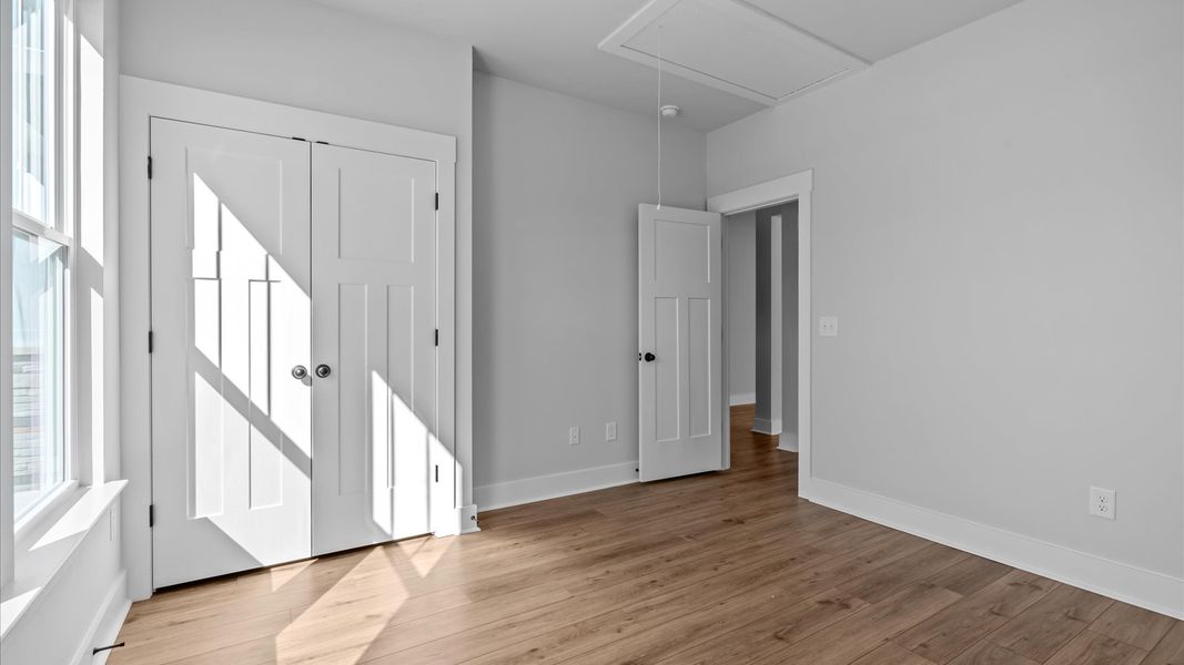 Desirable hardwood flooring in all bedrooms creates a cohesive and elegant interior