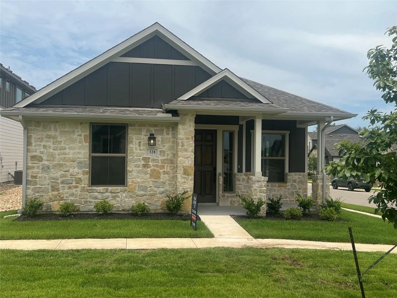 Front exterior of a new home in The Porch at Du Pre, Buda, TX, highlighting curb appeal (Image 1). Front exterior of a new home in The Porch at Du Pre, Buda, TX, highlighting curb appeal (Image 1).