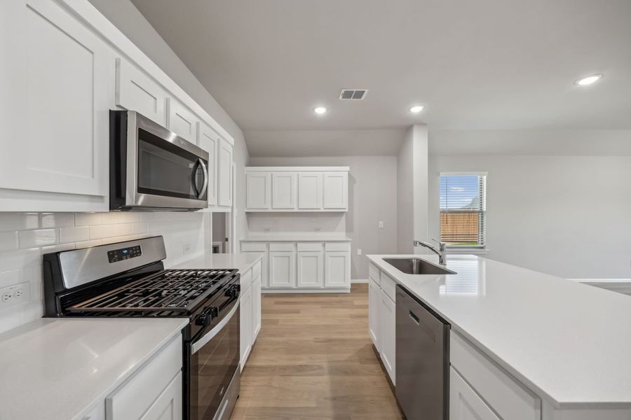 Kitchen in the Sabrina home plan by Trophy Signature Homes – REPRESENTATIVE PHOTO