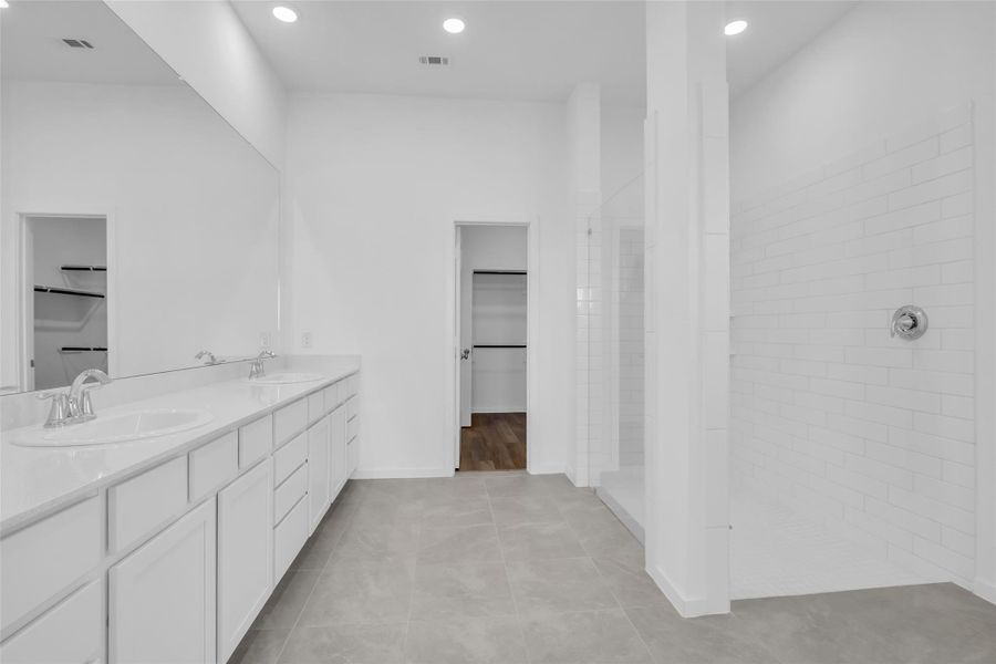 Primary Bathroom: Spacious layout featuring an extended dual-sink vanity, oversized walk-in shower, and a seamless view toward the walk-in closet for an efficient, well-connected suite design. Primary Bathroom: Spacious layout featuring an extended dual-sink vanity, oversized walk-in shower, and a seamless view toward the walk-in closet for an efficient, well-connected suite design.