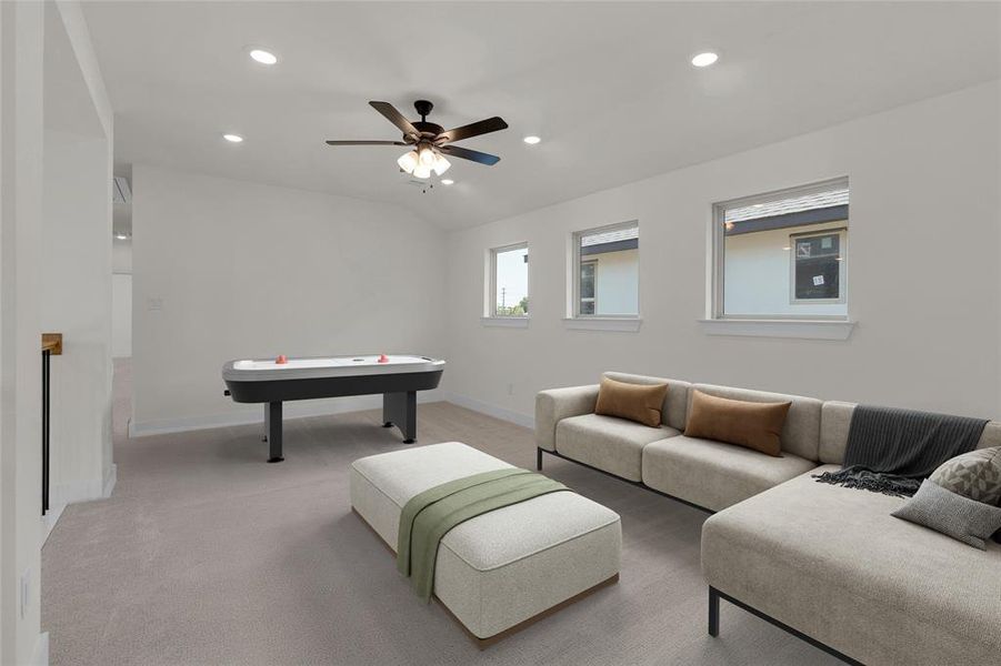 Spacious room featuring sloped ceilings, recessed lighting, and light gray carpeting